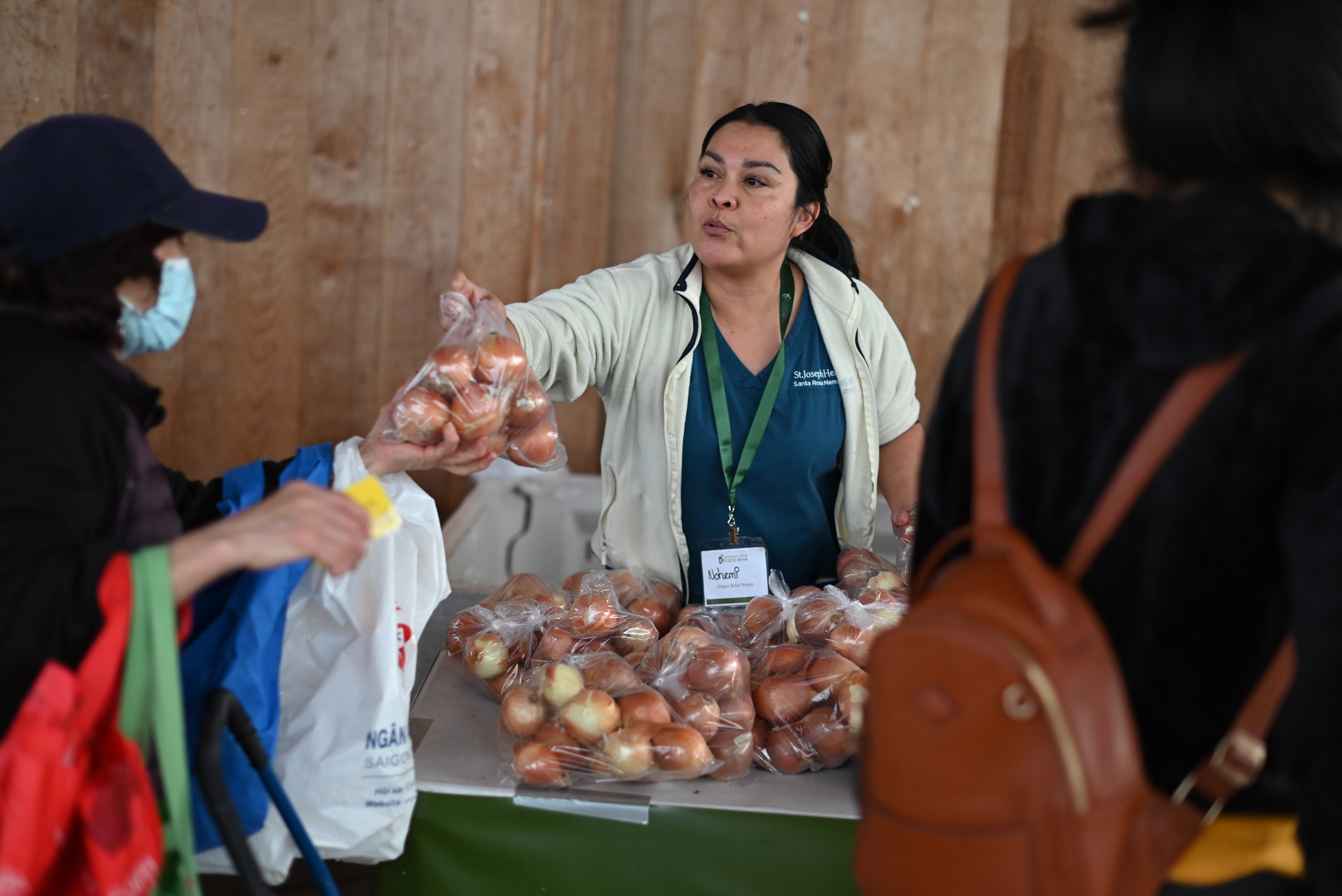 Woman distributing produce at Redwood Empire Food Bank
